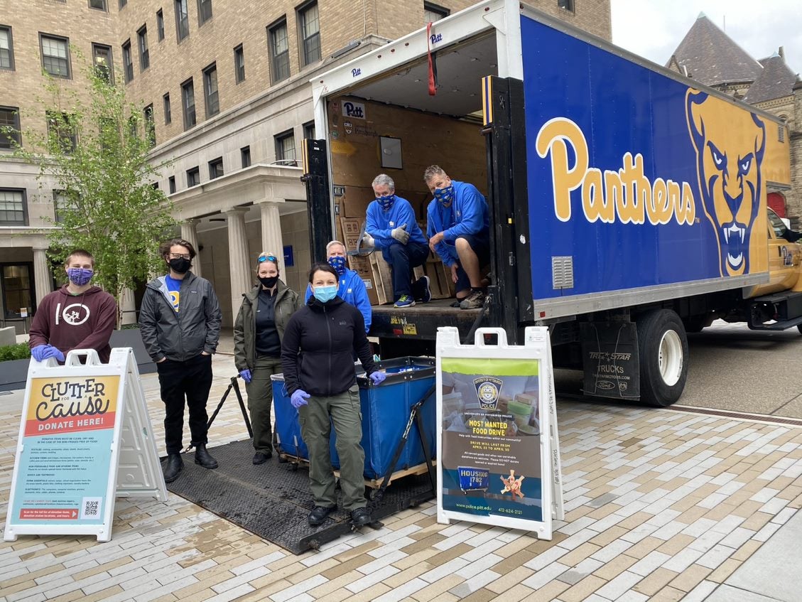 Members of the Pitt community remove bins used to collect donated canned goods and other non-perishable items.